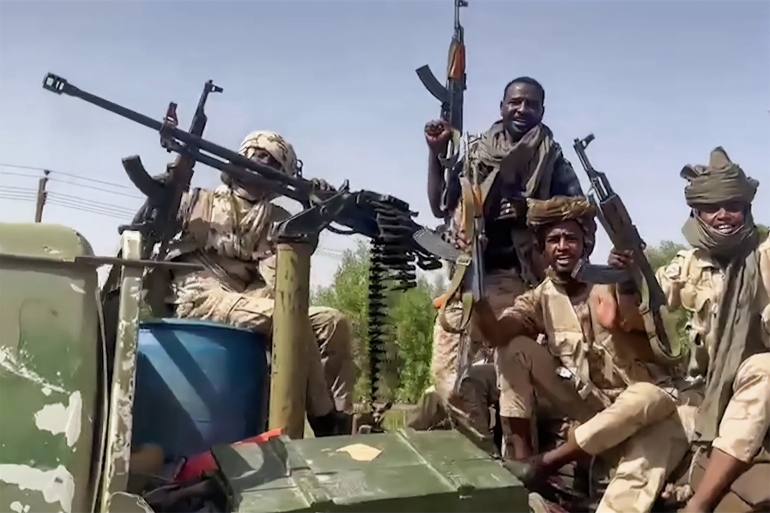 n this image grab taken from handout video footage released by the Sudanese paramilitary Rapid Support Forces (RSF) on April 23, 2023, fighters ride in the back of a technical vehicle (pickup truck mounted with a turret) in the East Nile district of greater Khartoum. A US-brokered ceasefire between Sudan's warring generals entered its second day on April 26, 2023, but remained fragile after witnesses reported fresh air strikes and paramilitaries claimed to have seized a major oil refinery and power plant. (Photo by Rapid Support Forces (RSF) / AFP) / === RESTRICTED TO EDITORIAL USE - MANDATORY CREDIT "AFP PHOTO / HO / SUDAN RAPID SUPPORT FORCES (RSF)" - NO MARKETING NO ADVERTISING CAMPAIGNS - DISTRIBUTED AS A SERVICE TO CLIENTS === - === RESTRICTED TO EDITORIAL USE - MANDATORY CREDIT "AFP PHOTO / HO / SUDAN RAPID SUPPORT FORCES (RSF)" - NO MARKETING NO ADVERTISING CAMPAIGNS - DISTRIBUTED AS A SERVICE TO CLIENTS ===