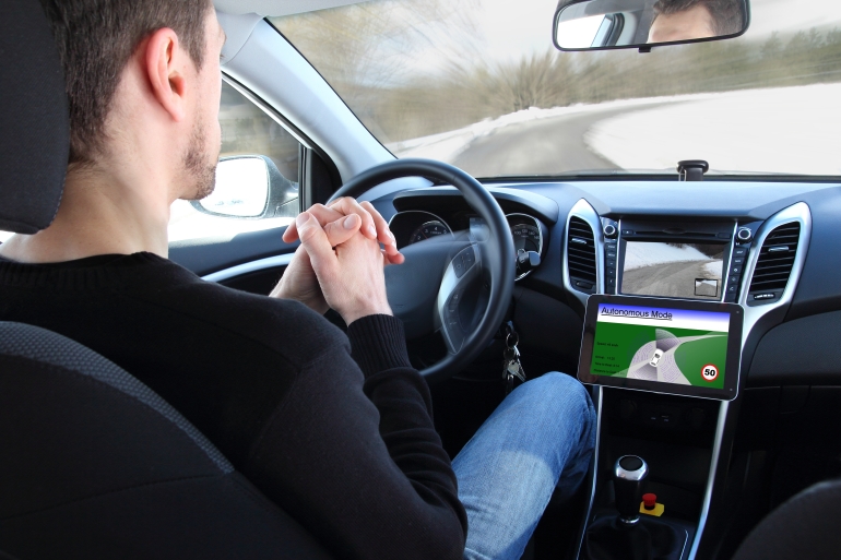 A man in a Autonomous driving test vehicle