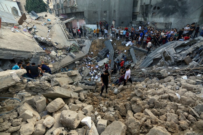 Palestinians inspect the site where there was a Greek Orthodox church, destroyed following Israeli airstrikes on Gaza City, Friday, Oct. 20, 2023. (AP Photo/Abed Khaled)