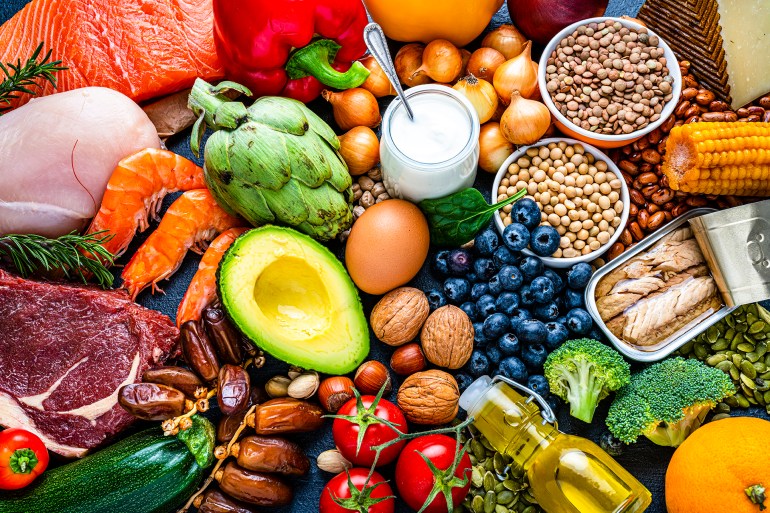 Overhead view of a large group of healthy raw food for flexitarian mediterranean diet. The composition includes salmon, chicken breast, canned tuna, cow steak, fruits, vegetables, nuts, seeds, dairi products, olive oil, eggs and legumes. High resolution 42Mp studio digital capture taken with SONY A7rII and Zeiss Batis 40mm F2.0 CF lens