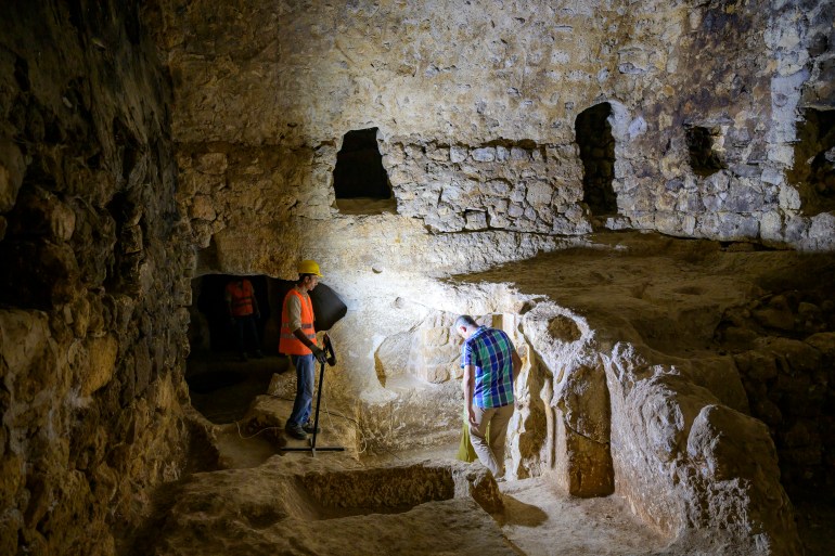 Municipal employees work inside the Matiate archaeological site underneath the town in Midyat in Mardin province, southeastern Turkey, on July 1, 2024. - Archaeologists stumbled upon the city-under-a-city "almost by chance" after an excavation of house cellars in the city of Midyat led to the discovery of a vast cave system in 2020. (Photo by Yasin AKGUL / AFP)