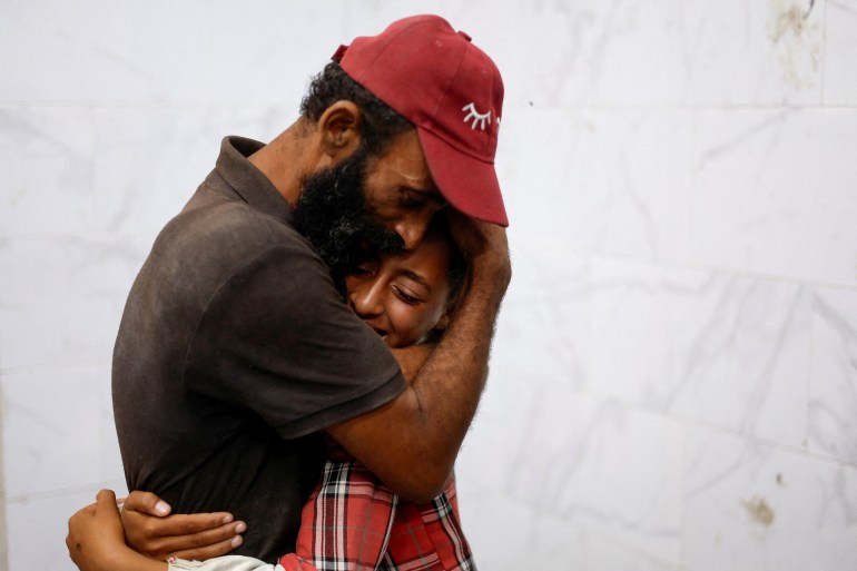 Mourners react during the funeral of Palestinians killed in Israeli strikes, amid the Israel-Hamas conflict, at Nasser hospital, in Khan Younis, southern Gaza Strip August 26, 2024. REUTERS/Mohammed Salem REFILE - QUALITY REPEAT