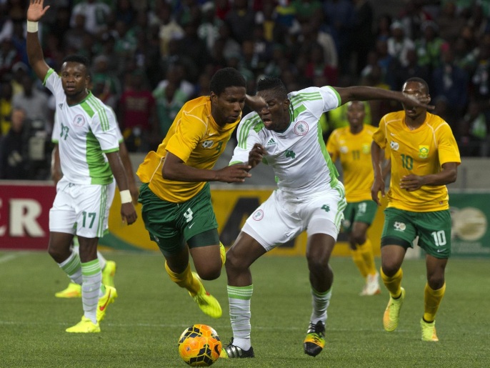 South Africa's defender Anele Ngcongca (L) vies for the ball with Nigeria's defender Kenneth Omeruo during the 2015 African Cup of Nations qualifying football match between South Africa and Nigeria on September 10, 2014 in Cape Town, South Africa. AFP PHOTO / RODGER BOSCH