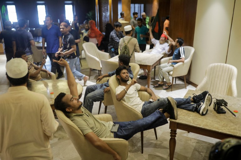 Anti-government protestors gather inside Prime Minister Sheikh Hasina's palace in Dhaka on August 5, 2024. - Bangladesh army chief Waker-Uz-Zaman spent nearly four decades rising to the top of the military and said on August 5, he was "taking full responsibility" after Prime Minister Sheikh Hasina was ousted and fled (Photo by K M ASAD / AFP)