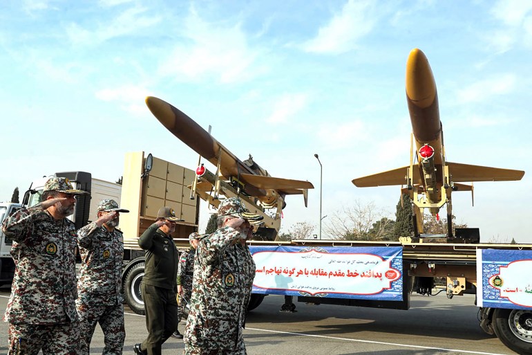 A handout picture provided by the Iranian Army office on December 10, 2023, shows Iranian army officials inspecting Iranian homemade Karrar drones displayed during an inauguration ceremony in Tehran. (Photo by Handout / Iranian Army office / AFP) / XGTY / RESTRICTED TO EDITORIAL USE - MANDATORY CREDIT 