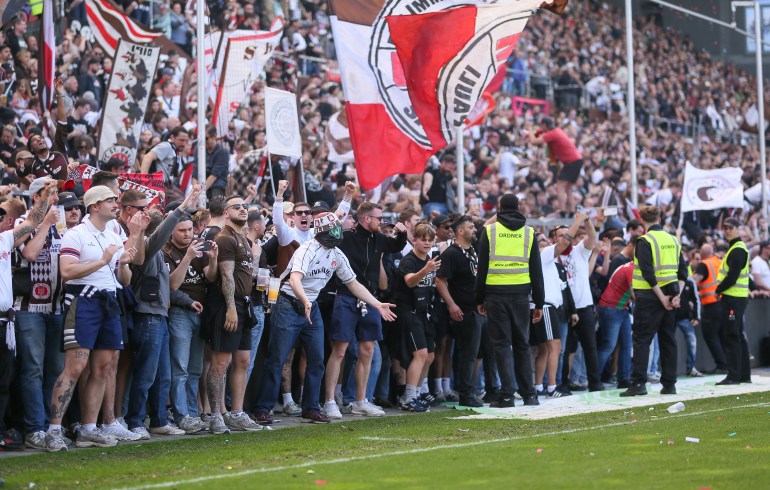 HAMBURG, GERMANY - MAY 12: St. Pauli fans wait on the sideline to invade the pitch to celebrate their promotion to the Bundesliga minutes before the final whistle during the Second Bundesliga match between FC St. Pauli and VfL Osnabrück at Millerntor Stadium on May 12, 2024 in Hamburg, Germany. (Photo by Selim Sudheimer/Getty Images)