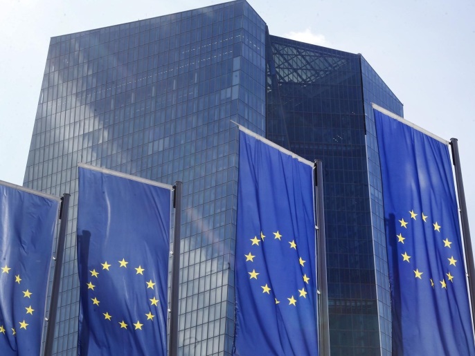 European flags wave in front of the headquarters of the European Central Bank in Frankfurt, Germany, Monday, July 6, 2015, the day after Greece voted "no" for more austerity measures in exchange for a bailout of its bankrupt economy. (AP Photo/Michael Probst)