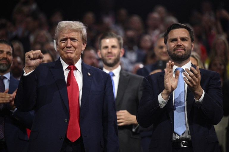 US former President and 2024 Republican presidential candidate Donald Trump (L) raises a fist next to US Senator from Ohio and 2024 Republican vice-president candidate J. D. Vance during the first day of the 2024 Republican National Convention at the Fiserv Forum in Milwaukee, Wisconsin, July 15, 2024. - Donald Trump won formal nomination as the Republican presidential candidate and picked a right-wing loyalist for running mate, kicking off a triumphalist party convention in the wake of last weekend's failed assassination attempt. (Photo by Brendan SMIALOWSKI / AFP)