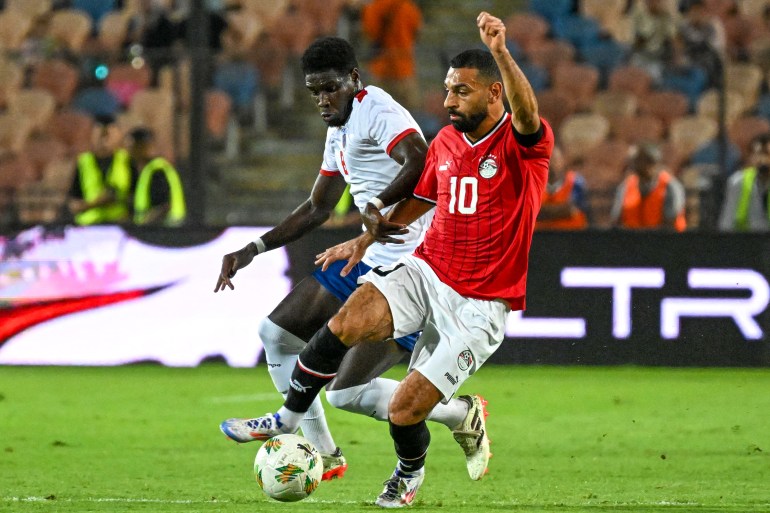 Egypt's forward #10 Mohamed Salah vies for the ball with Cape Verde's forward #8 Joao Paulo Fernandes during the 2025 CAF Africa Cup of Nations (CAN) Group C qualifying match between Egypt and Cape Verde at the Cairo International Stadium on September 6, 2024. (Photo by Khaled DESOUKI / AFP)