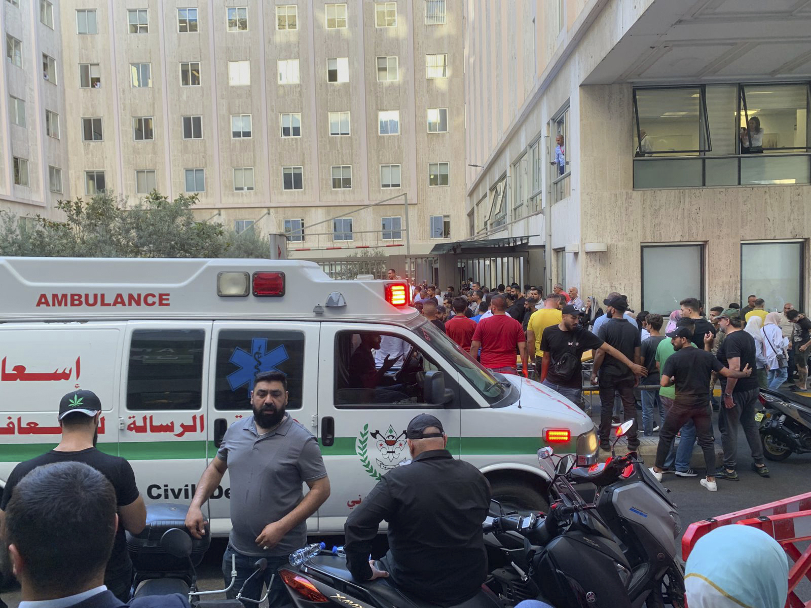 People gather outside the American University hospital after the arrival of several men who were wounded by exploded handheld…