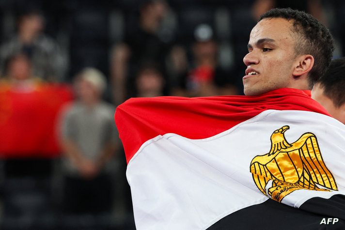 Gold medallist Egypt's Mohamed Elmenyawy celebrates during the victory ceremony for the para Powerlifting Men's up to 59kg…