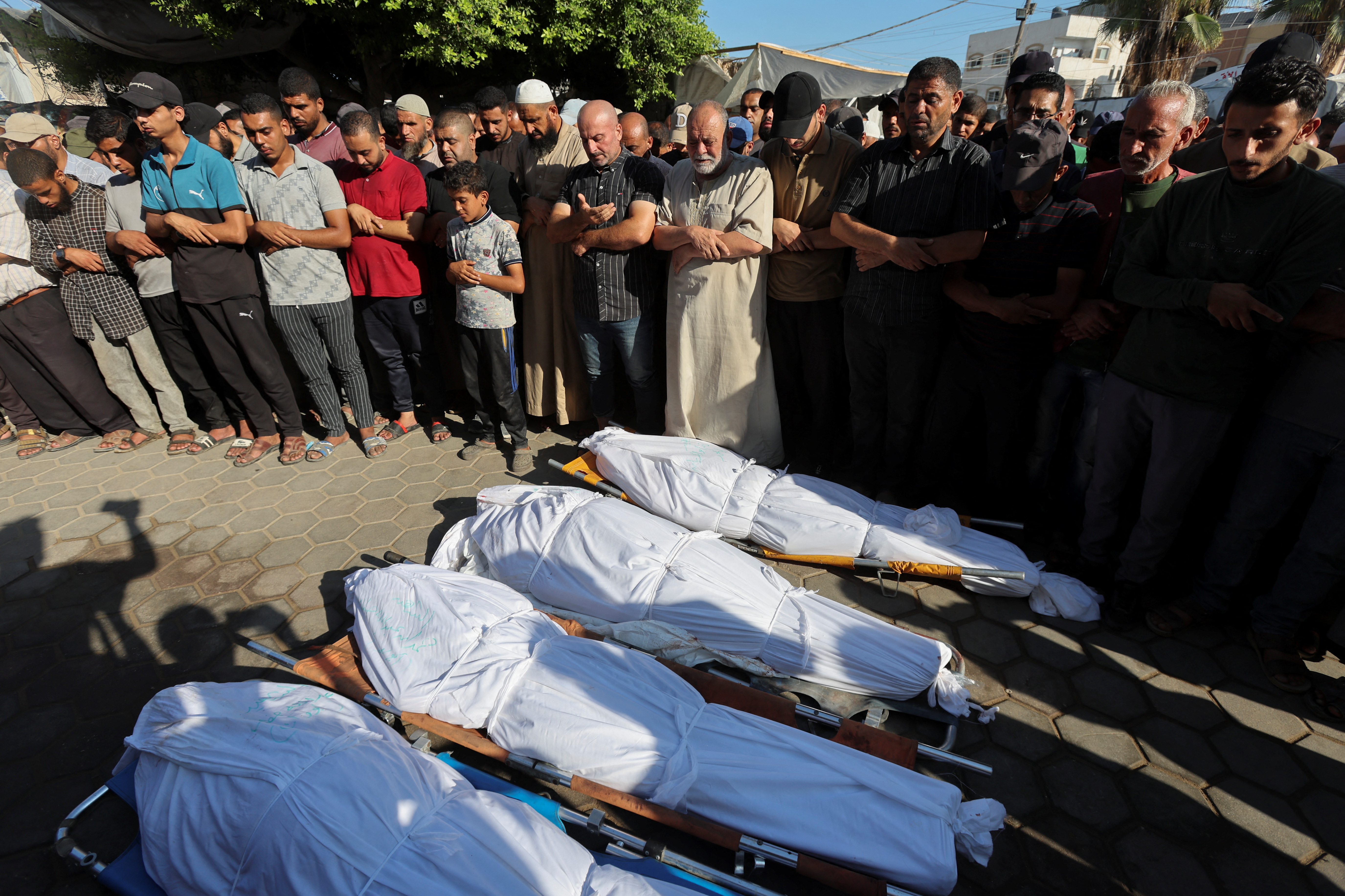 Palestinians mourn loved ones killed in Israeli strikes, in Deir Al-Balah in the central Gaza Strip