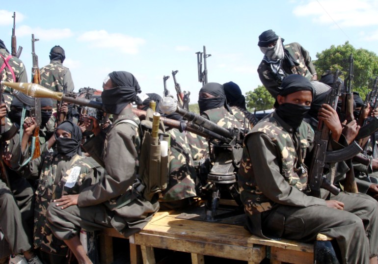 Militants of al Shabaab display their weapons on the outskirts of Mogadishu, December 8, 2008. The hardline Islamist insurgent group al Shabaab has taken control of a central Somali trading town after fighting that killed at least 13 people and wounded dozens of others, residents said. REUTERS/Feisal Omar (SOMALIA)