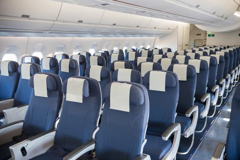 Empty airplane cabin seats ادوبي ستوك