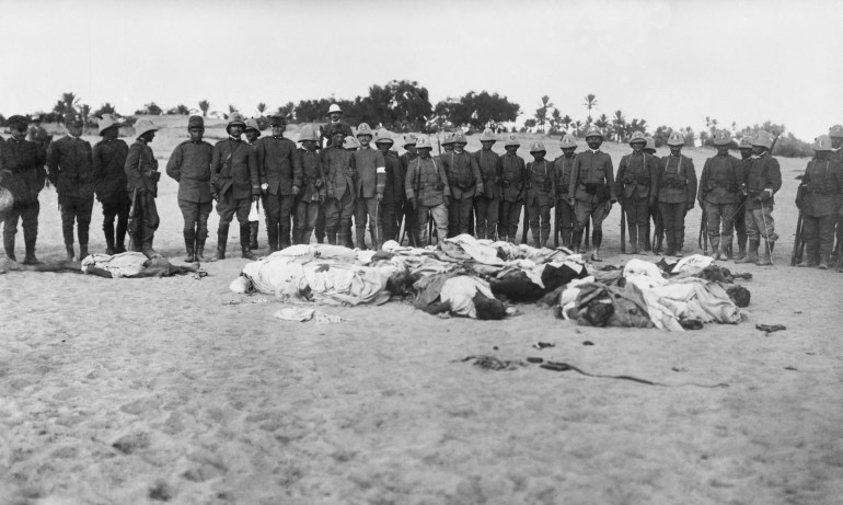 Italian soldiers gathered around dead bodies of Arabs during the Italo-Turkish War. The Italian invasion was resisted by a small force of 20,000 Arabs and 8,000 Turks, who fought with guerrilla tactic