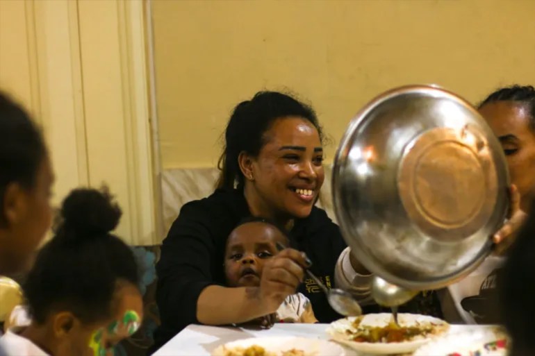 **داخلية** Sudanese women and children gather for dinner at the Sudanese Cultural Centre in Beirut الجزيرة