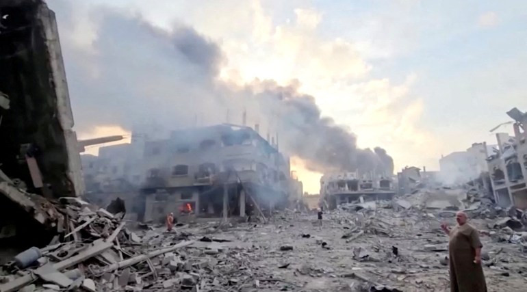 People survey the destruction at Gaza's Jabalia refugee camp, following Israeli strikes on the enclave, October 14, 2023 in this still image from video obtained by REUTERS. ATTENTION EDITORS - THIS IMAGE HAS BEEN SUPPLIED BY A THIRD PARTY. TPX IMAGES OF THE DAY