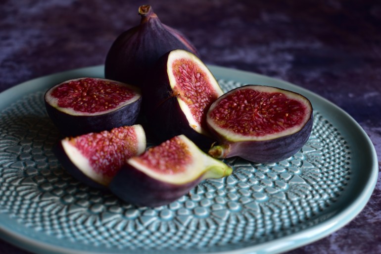 Close up of figs on decorative plate, Still life photography