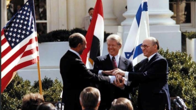 U.S. President Jimmy Carter, Egyptian President Anwar Sadat and Israeli Prime Minister Menachem Begin join hands in celebration of the signing of the ÒTreaty of Peace Between the Arab Republic of Egypt and the State of IsraelÓ at the White House in Washington, D.C., March 26, 1979. Courtesy Jimmy Carter Library/National Archives/Handout via REUTERS ATTENTION EDITORS - THIS IMAGE WAS PROVIDED BY A THIRD PARTY