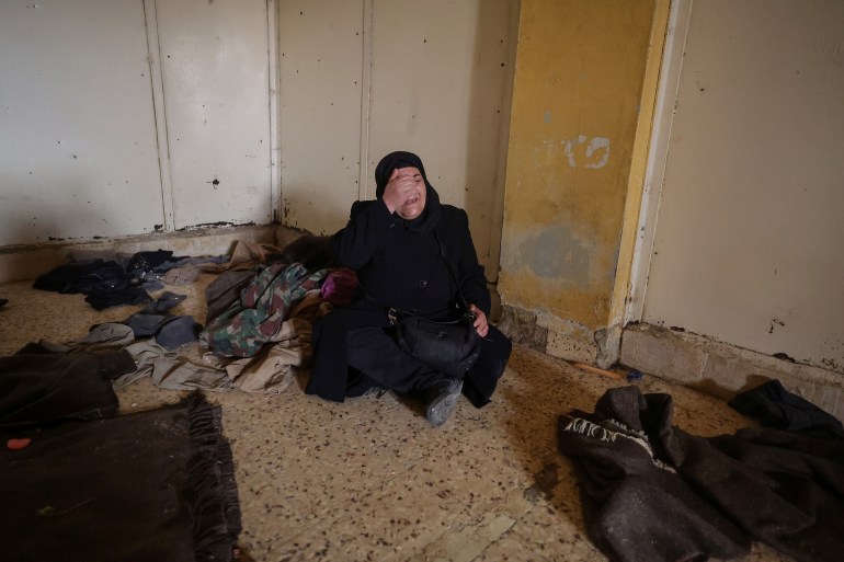 Ibtissam Al-Nadaf who said she is still mourning two sons, one killed by a sniper during the siege of Al-Assali, the other disappeared into Sednaya prison in 2018, reacts as she hopes for any sign of her son as she sits inside a cell at the Sednaya prison, which was known as a slaughterhouse under Syria's Bashar al-Assad rule, after fighters of the ruling Syrian body ousted Bashar al-Assad, in Sednaya, Syria December 24, 2024. REUTERS/Zohra Bensemra