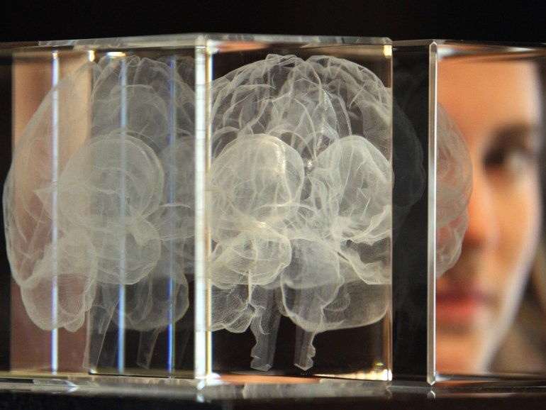 LONDON, ENGLAND - MARCH 27: Wellcome trust employee Zoe Middleton poses behind an artwork entitled 'My Soul' by Katharine Dowson, which consists of a laser etched lead chrystal glass formation in the shape of a brain, and was created using the artists own MRI Scan, at Wellcome Collection on March 27, 2012 in London, England. The exhibit makes up part of the Wellcome Collection's major new exhibition, 'Brains' which includes slices of Einstein's brain, 3000 year o