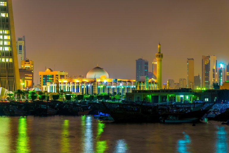 The Grand mosque of Kuwait behind a dhow port near the Sharq souq in Kuwait druing night.