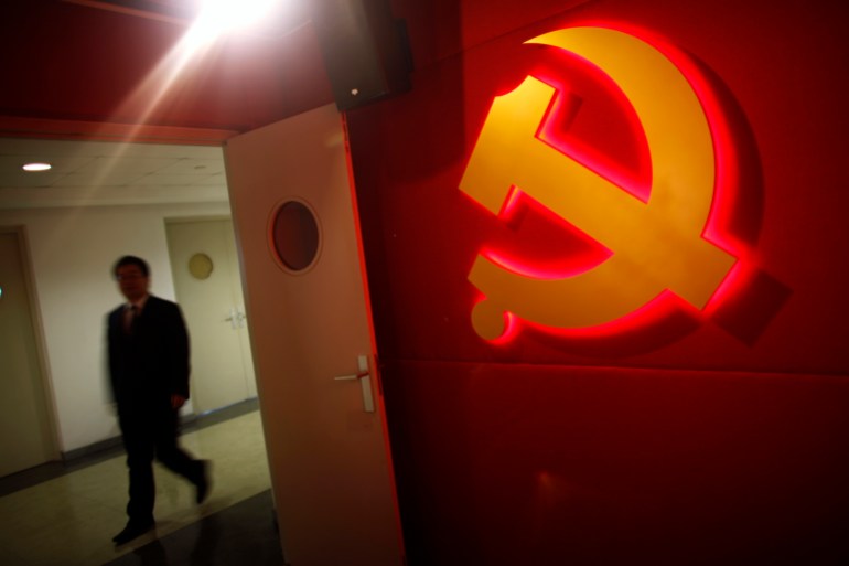 A trainee walks past a communist party logo as he attends a training course at the communist party school called China Executive Leadership Academy of Pudong in Shanghai, September 24, 2012. China's Communist Party has dramatically stepped up its training of the country's roughly 40 million party and government officials in the past decade. With public scrutiny of cadre behaviour growing via social media, the party is likely to call for continued, and deepened, cadre education at the upcoming 18th Party Congress. At the vanguard of this education drive, alongside a Central Party School in Beijing, are three "Executive Leadership Academies" which opened in 2005 for middle-ranking and senior officials in Shanghai, Yan'an and Jinggangshan. The curriculum covers Marxism, Leninism and Mao Zedong Thought, but students may also take finance courses, receive in-depth media training or role-play crisis management scenarios on everything from disease outbreaks to train wrecks. REUTERS/Carlos Barria (CHINA - Tags: POLITICS SOCIETY BUSINESS LOGO)