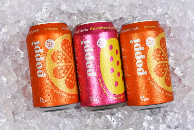 IRVINE, CALIFORNIA - 6 SEPT 2024: Three cans of Poppi Prebiotic Soda on a bed of ice.