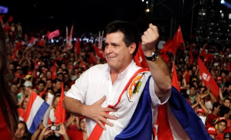 In this April 5, 2013 file photo, Horacio Cartes, presidential candidate of the Colorado Party, dances during a campaign rally in Capiata, Paraguay, the year after Paraguay’s Senate removed then-President Fernando Lugo from office in a rapid impeachment trial [File: Jorge Saenz/AP]