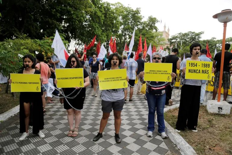Paraguayans remember the murdered and missing as they commemorate the end of Alfredo Stroessner’s rule in Asuncion, Paraguay on February 2, 2019 [Jorge Adorno/Reuters]