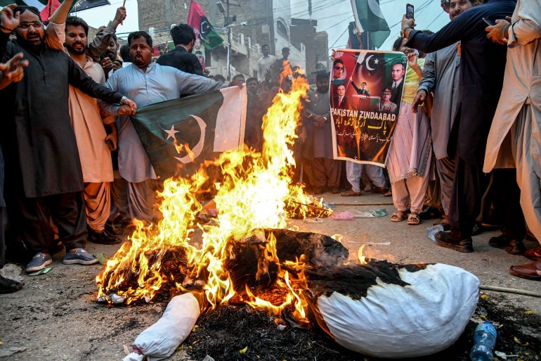 Pakistan Peoples Party (PPP) activists burn an effigy of India's Prime Minister Narendra Modi during an anti-India protest in Larkana, Sindh province, on May 8, 2025.