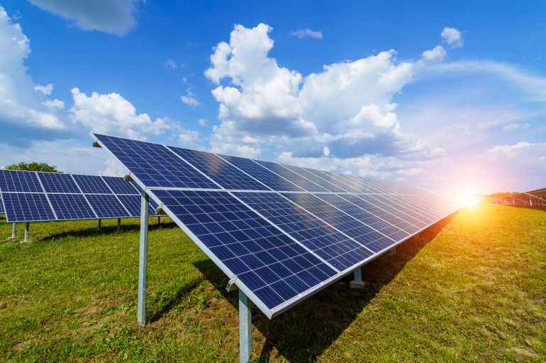 Solar panels on the sky background. Solar power plant. Blue solar panels. Alternative source of electricity. Solar farm.; Shutterstock ID 1696361656; purchase_order: aljazeera ; job: ; client: ; other: