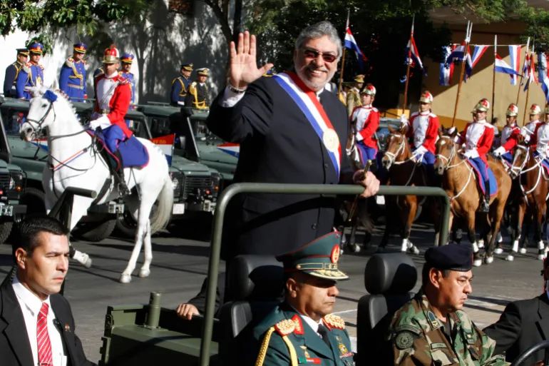 Paraguay’s President Fernando Lugo rides a military vehicle before the start of a mass to commemorate the country’s 201st year of independence, in front of the Metropolitan Cathedral of Asuncion, in Asuncion on May 14, 2012, one month before the Curuguaty massacre [Jorge Adorno/Reuters]