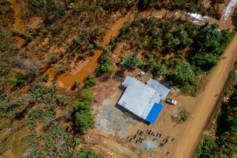 Nickel mining facility in the village of Kawassi, District of Obi, Obi Island, South Halmahera Regency, Tuesday, Oct. 18, 2022, showing nickel mining run offs from the River Kawassi streaming behind the village, and in the distance, nickel ming run offs from River Todoku. At least five nickel mining companies are operating in the area behind Kawassi village, such as PT Trimegah Bangun Persada, PT Megah Surya Pertiwi (MSP), PT Gane Perm Sentosa, PT Halmahera Jaya Feronikel (HJF) and PT Harita Persada Lygend. The island opposite is Malamala Island, whose nickel mining concession is held by PT Rimba Kurnia Alam. All companies are subsidiaries of the Chinese-funded Harita Group. In the far distance is Obilatu Island. There are two coal-powered power plants in the area, according to Carbonbrief.org, namely the Jinchuan Group WP & RKA Power Station, with the capacity of 150 megawatt and carbon emission of 0.76 megaton/year, and MSP Pulau Obi Power Station, with the capacity of 114 megawatt and carbon emission of 0.58 megaton/year. The mining in Obi Island has been affecting the locals, due to water pollution from nickel run-offs, air pollution due to smog and dust, and land grabbing. Access to rivers as such River Todoku and River Kawassi in the village is no longer available, since river water has turned ochre-colored and no longer consumable by locals. A lake close to the area is Lake Karo, whose water level gradually decreases due to its supply for nickel mining activity around the lake. The majority of the world's nickel reserves is in Indonesia. By 2025, the country is expected to produce more than 60% of the world's nickel supply, which is used for making batteries for electric vehicles. (Photo by Joshua Irwandi/For The Washington Post via Getty Images)