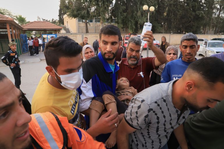 Palestinians evacuate patients from the European hospital in Khan Younis, Gaza, after it was hit by an Israeli army airstrike, Tuesday, May 13, 2025. The Israeli military said it had carried out a strike targeting what it said was a Hamas "command and control center" located beneath the hospital. (AP Photo/Mariam Dagga)