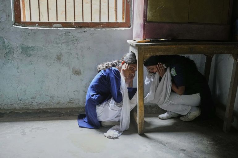 School students participate in a mock drill trained by civil defence members to respond in case of attack in Guwahati, India, Saturday, May 10, 2025 amid rising fears of wider conflict following India's strikes in Pakistan. Anupam Nath - AP
