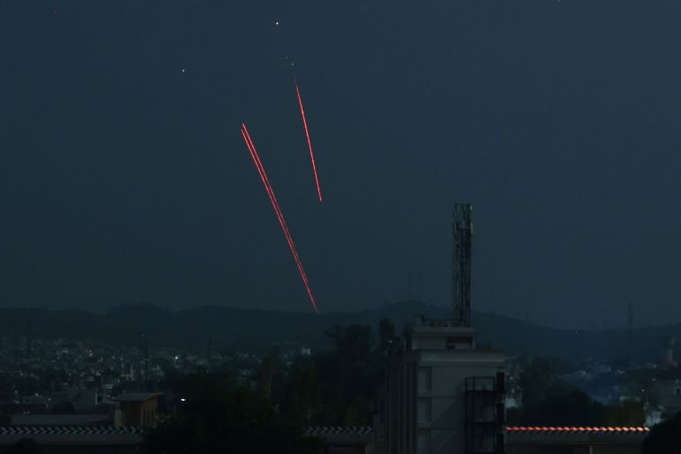 Trails from an Indian air defence system are seen above Jammu during a Pakistani strike on May 9, 2025. The Indian army on May 10 reported fresh Pakistani attacks along the border with its arch-foe as the conflict between the nuclear-armed neighbours spiralled. (Photo by Rakesh BAKSHI / AFP)