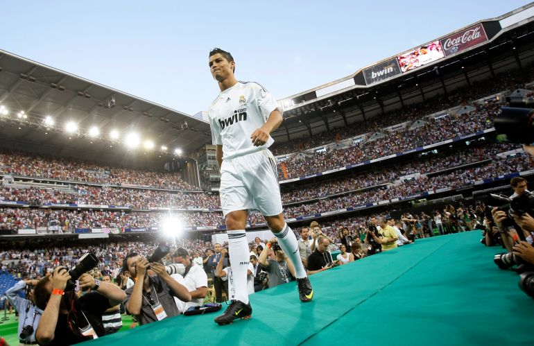 Real Madrid's new Portuguese soccer player Cristiano Ronaldo walks onto the stage at Santiago Bernabeu stadium
