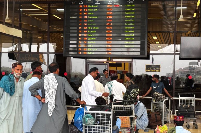 Passengers wait at Jinnah International Airport after all domestic and international flights were cancelled in Karachi on May 7, 2025.