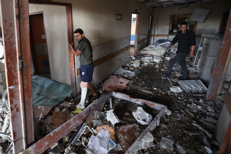 Palestinians inspect the destruction inside Nasser hospital in Khan Yunis in the southern Gaza Strip following an Israeli strike early on May 13, 2025, in which Palestinian journalist Hassan Aslih was killed along with several others.