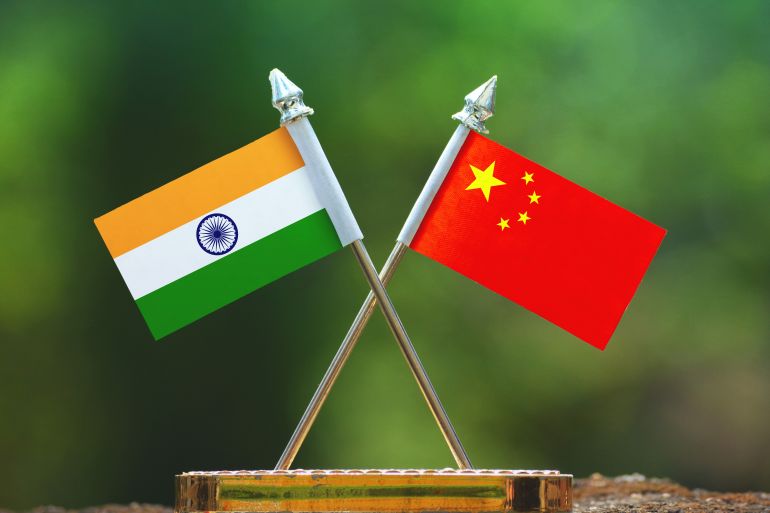 China and India small flag with blur green background; Shutterstock ID 1075372373; purchase_order: aljazeera ; job: ; client: ; other: