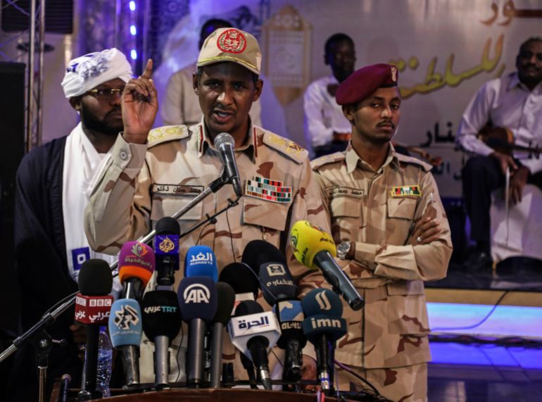 In this Saturday, May 18, 2019 photo, Gen. Mohammed Hamdan Dagalo, better known as Hemedti, the deputy head of the military council that assumed power in Sudan after the overthrow of President Omar al-Bashir, speaks to journalists in Khartoum, Sudan. At 44, he is the youngest member of the council. He says he refused orders from al-Bashir to fire on the protesters, and he praised them as recently as last weekend. (AP Photo)