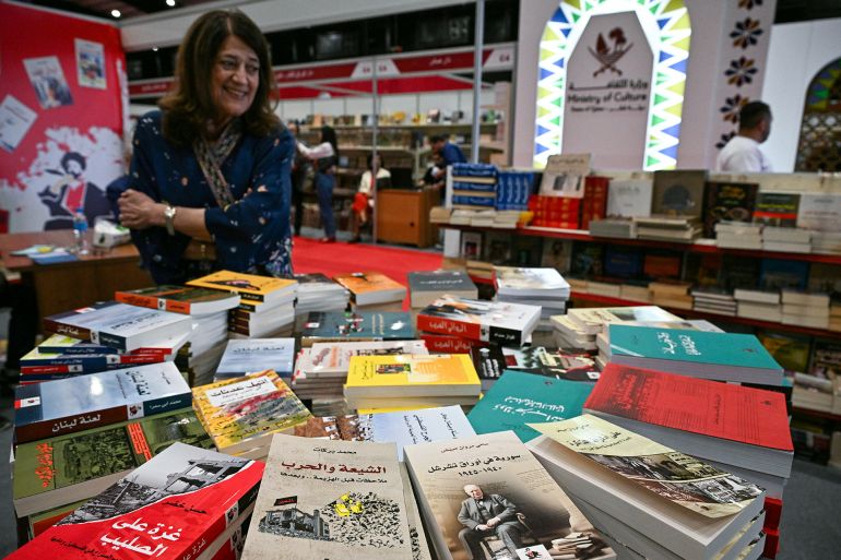 A woman looks at books displayed during the 66th Beirut Arab International Bookfair in the Lebanese capital on May 15, 2025. (Photo by Joseph EID / AFP)