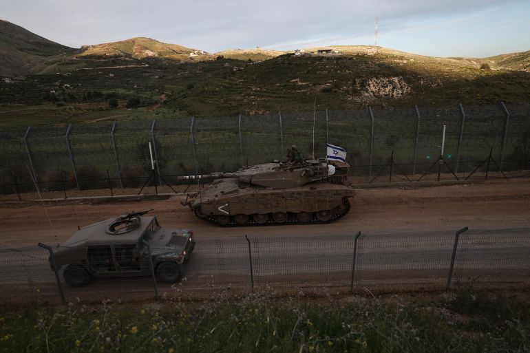 epa12084273 Israeli Merkava tanks roll past the ceasefire line, on their way to the buffer zone between Israel and Syria near the village of Majdal Shams in the Israeli-annexed Golan Heights, 08 May 2025. The Israeli army reported that it has begun operating a mobile forward facility for triaging the wounded in southern Syria, in the area of the village of Hadar. EPA-EFE/ATEF SAFADI