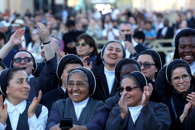 VATICAN CITY, VATICAN - MAY 08: Faithful and nuns celebrate on St Peter's Square as they witness white smoke after a new pope is elected at the conclave on May 08, 2025 in Vatican City, Vatican. White smoke was seen over the Vatican early this evening as the Conclave of Cardinals took just two days to elect Cardinal Robert Francis Prevost, who will be known as Pope Leo (Leone) XIV, as the 267th Supreme Pontiff after the death of Pope Francis on Easter Monday. (Photo by Franco Origlia/Getty Images)