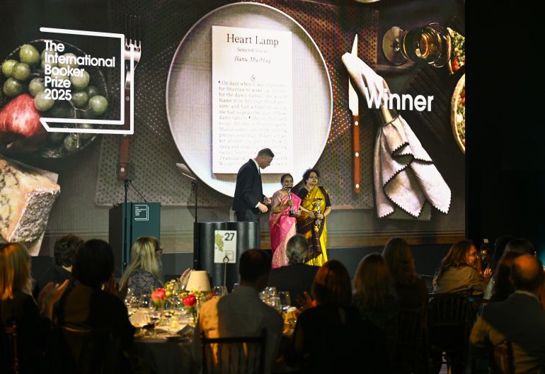 LONDON, ENGLAND - MAY 20: Chair of Judges Max Porter (L) with Banu Mushtaq, author of "Heart Lamp", (C) and Deepa Bhasthi, translator, winners of The International Booker Prize 2025 onstage at the Tate Modern on May 20, 2025 in London, England. (Photo by Kate Green/Getty Images)