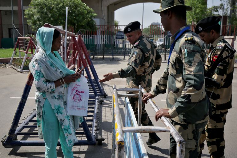 An Indian citizen meets with Border Security Force officers after she was denied permission to cross to Pakistan, at the Attari border check post near Amritsar, India, April 24, 2025. REUTERS/Stringer