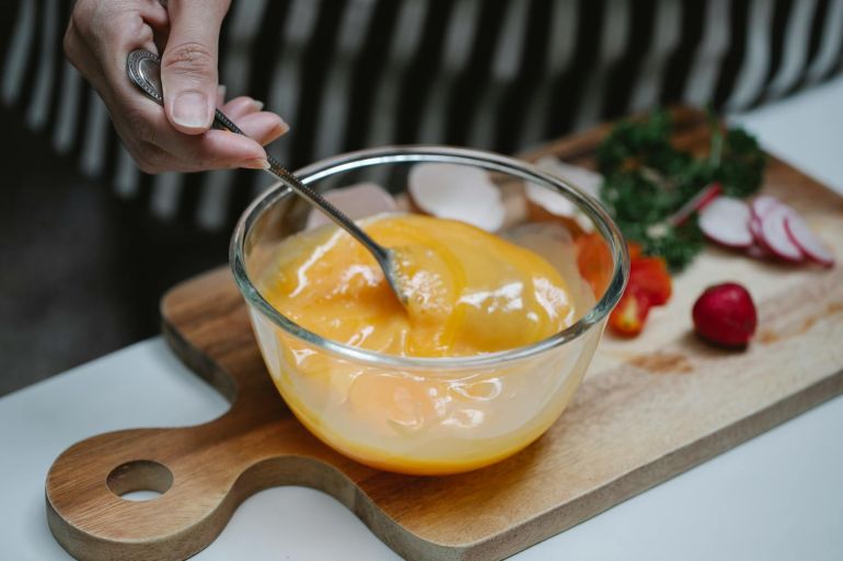 Woman mixing ingredients for breakfast in kitchen
