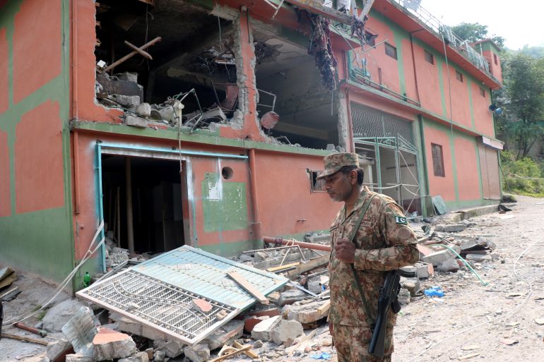 A Pakistan Army soldier stands in front of damaged Bilal Mosque after it was hit by an Indian strike in Muzaffarabad, the capital of Pakistan-administered Kashmir, May 7, 2025. REUTERS/Stringer
