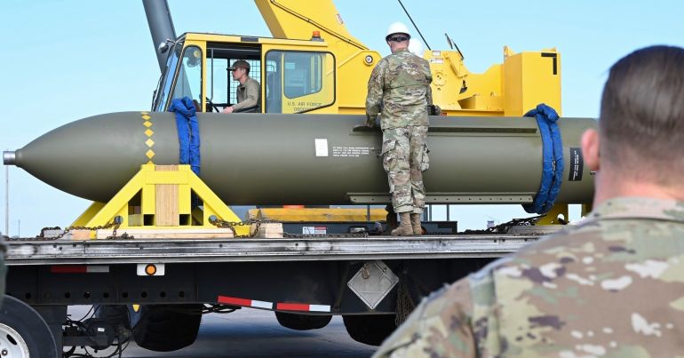 In this photo released by the U.S. Air Force on May 2, 2023, airmen look at a GBU-57, or the Massive Ordnance Penetrator bomb, at Whiteman Air Base in Missouri. That U.S. bomb, designed to destroy underground sites at the height of concerns a decade ago over Iran's nuclear program, has briefly reappeared amid new tensions with the Islamic Republic. (U.S. Air Force via AP)